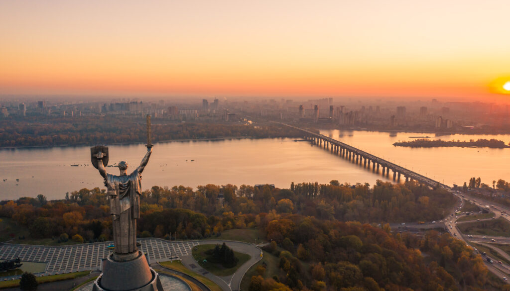 Kiev skyline over beautiful fiery sunset, Ukraine. Monument motherland.