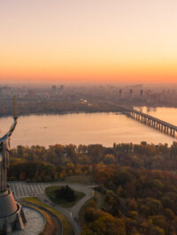 Kiev skyline over beautiful fiery sunset, Ukraine. Monument motherland.